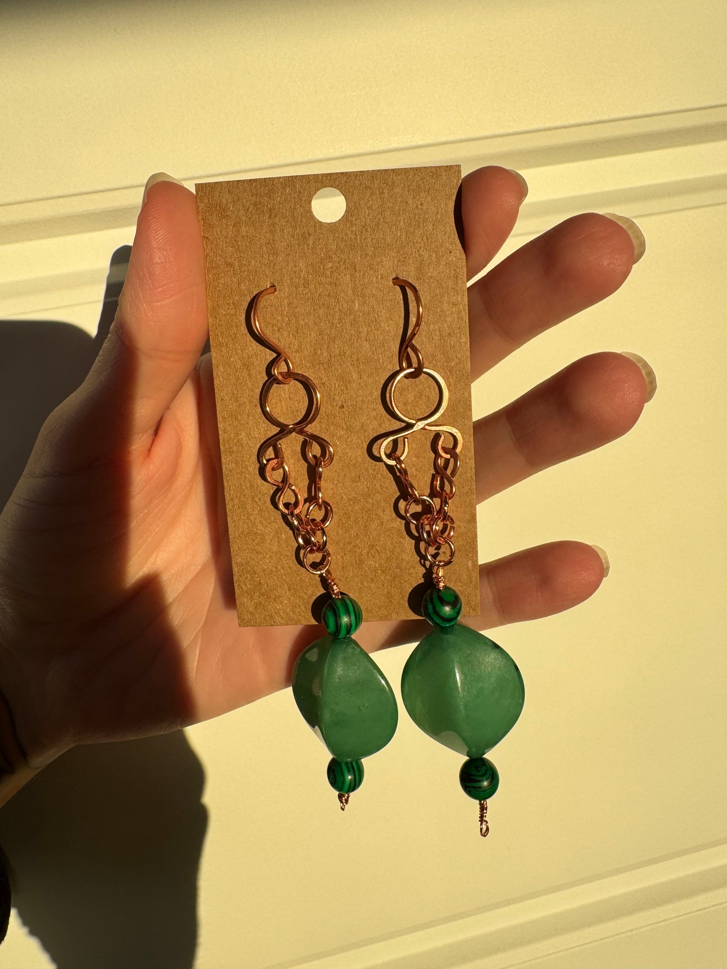 Copper dangle earrings with green beads