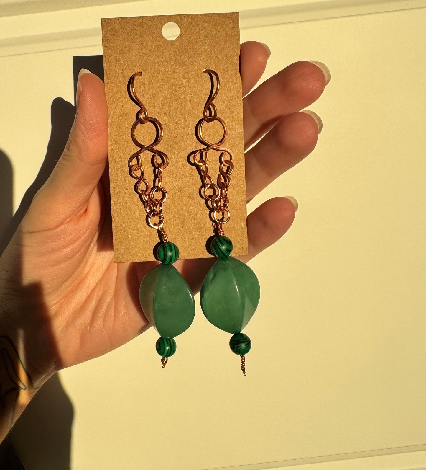 Copper dangle earrings with green beads