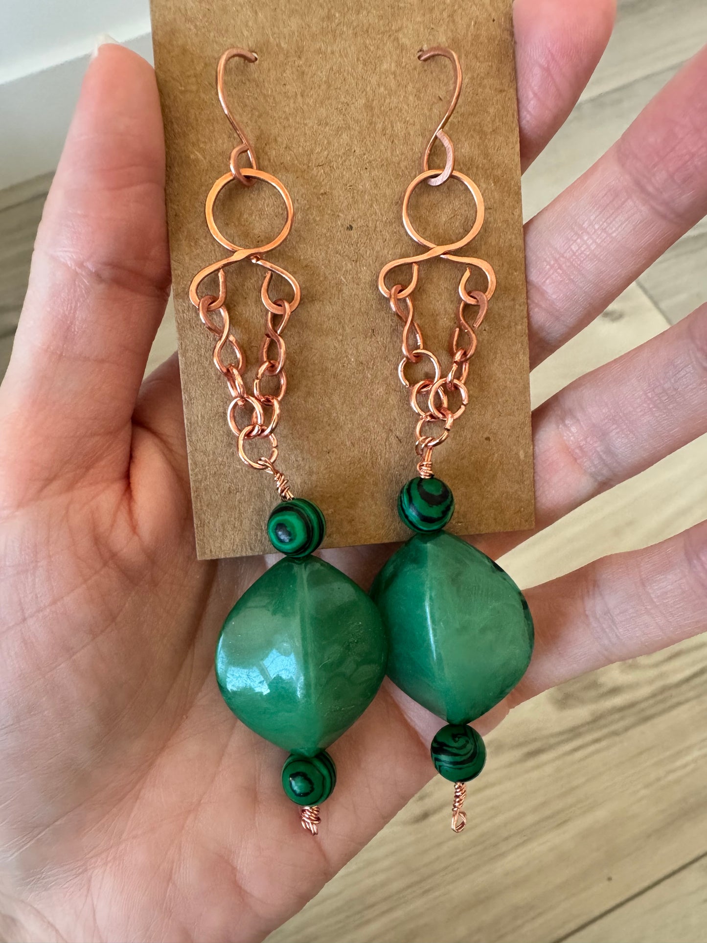 Copper dangle earrings with green beads
