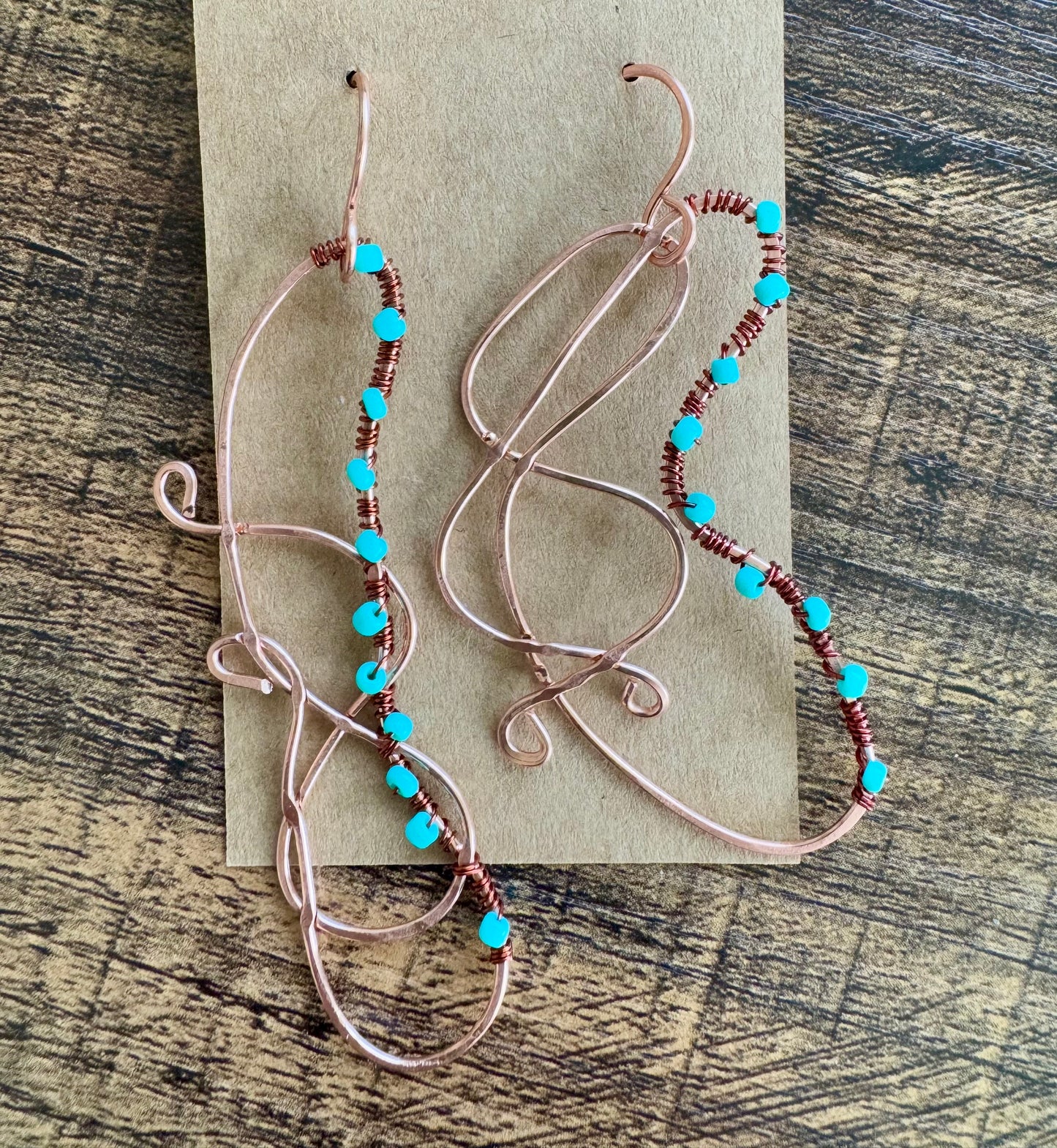 Abstract copper earrings with blue beads