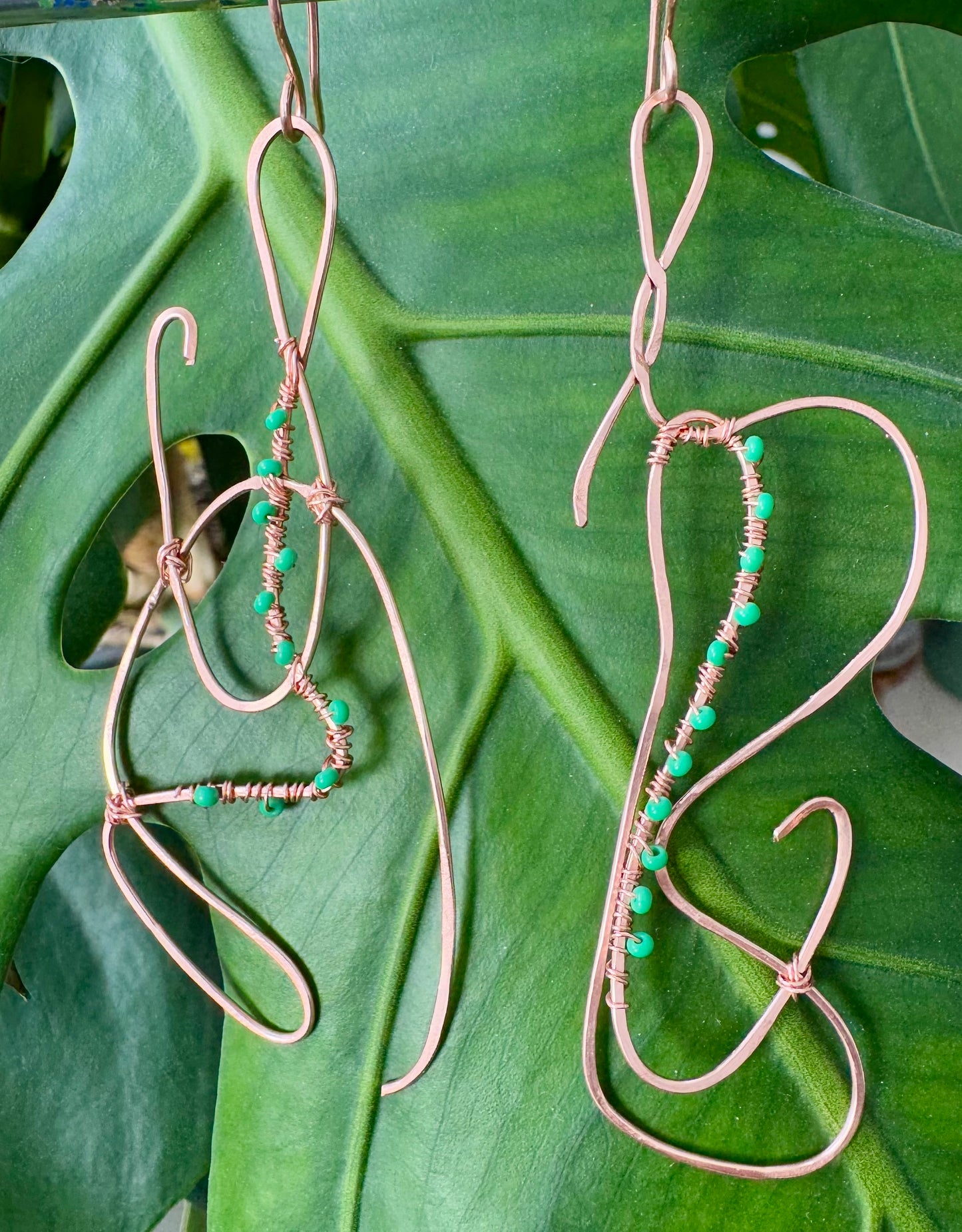 Abstract copper earrings with green beads