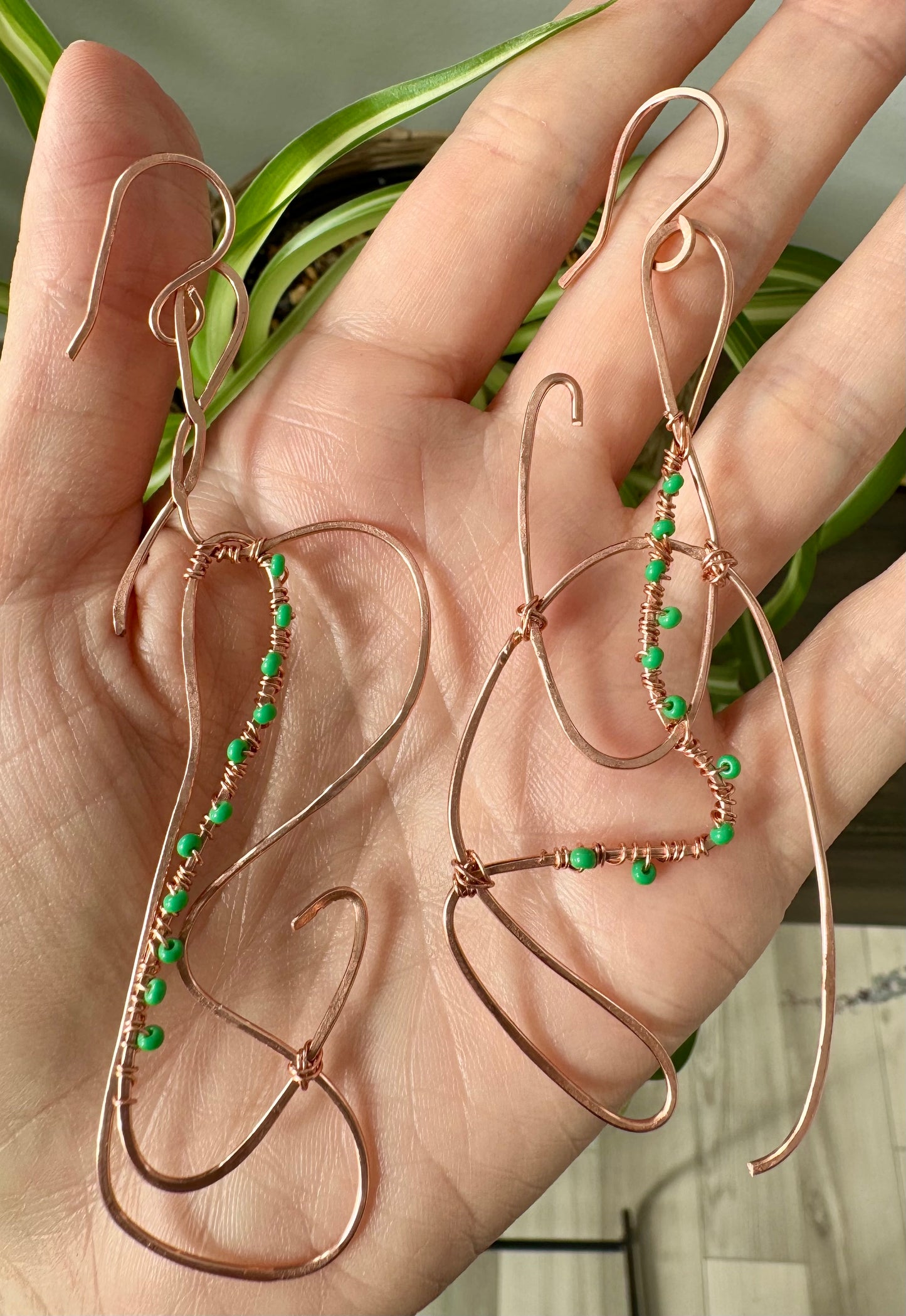 Abstract copper earrings with green beads