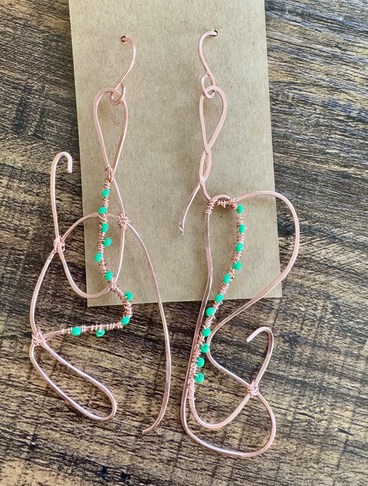 Abstract copper earrings with green beads