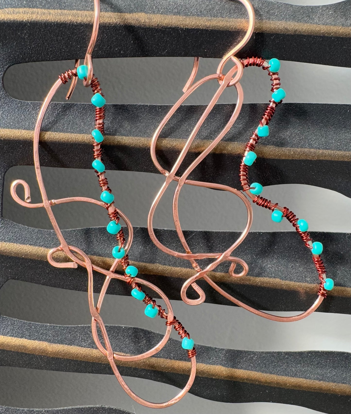 Abstract copper earrings with blue beads