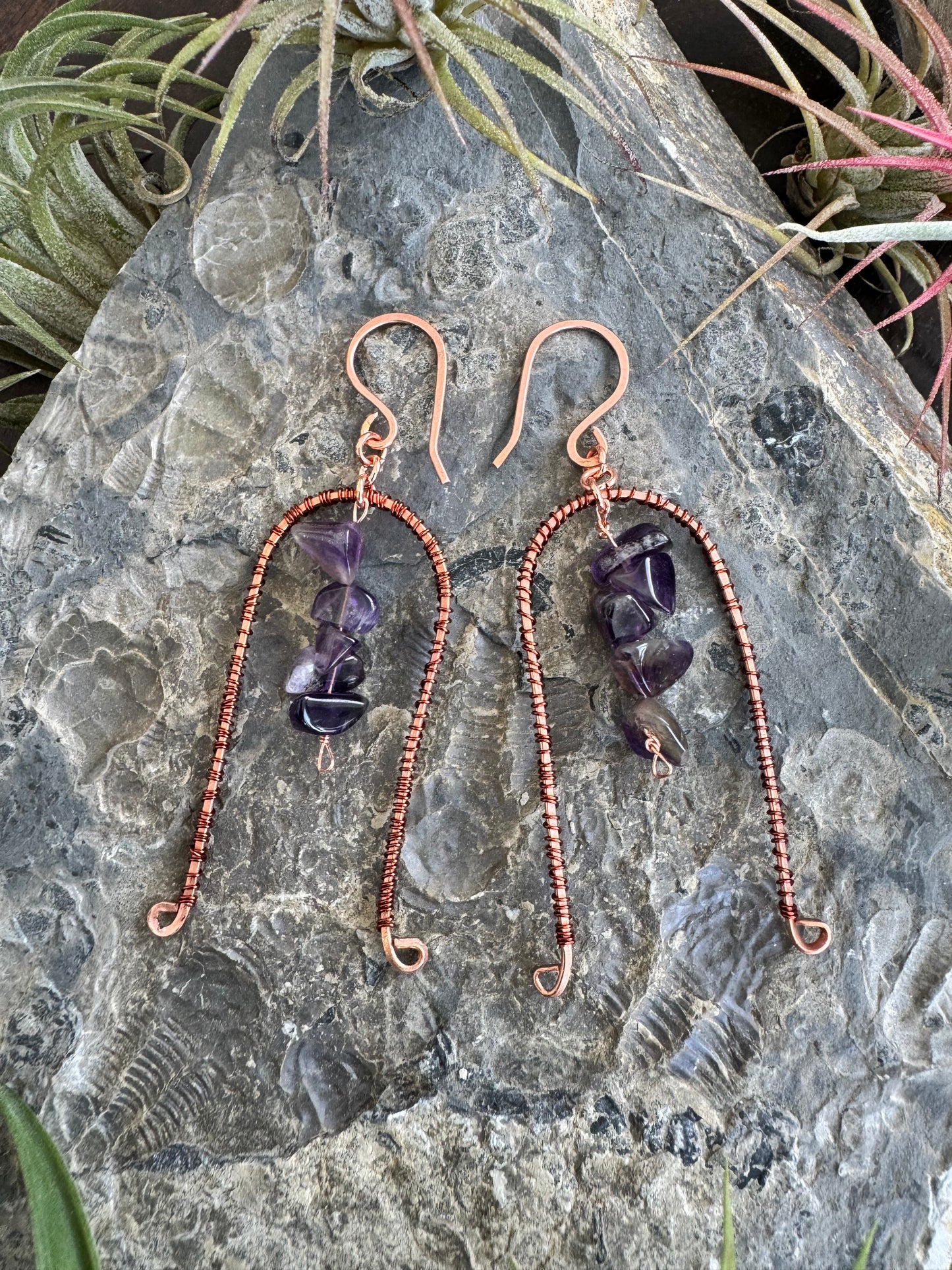 Arched copper earrings with purple stones