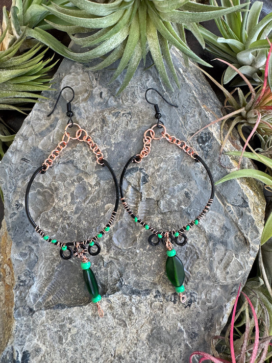 Black hoop earrings with green beads