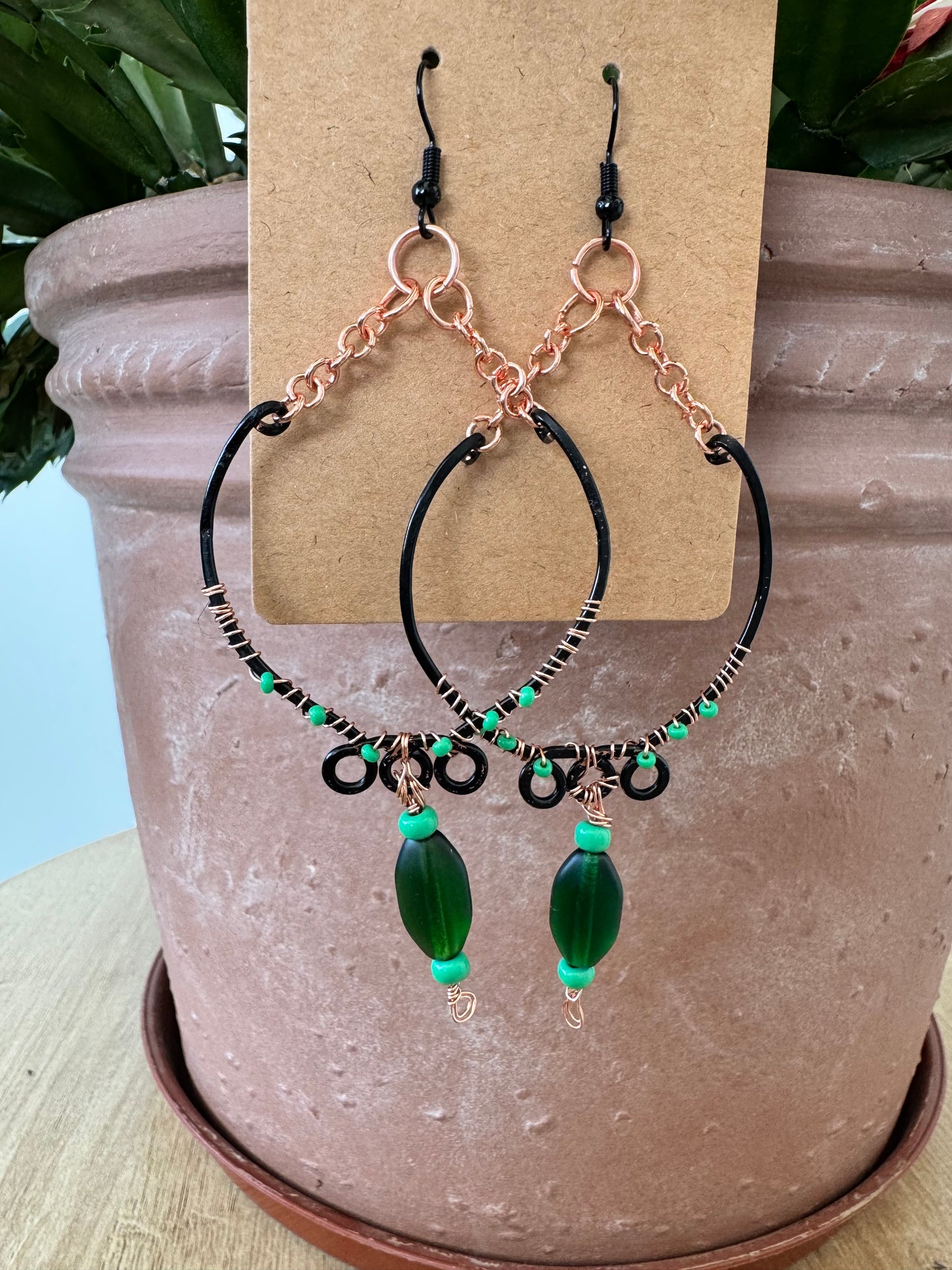 Black hoop earrings with green beads