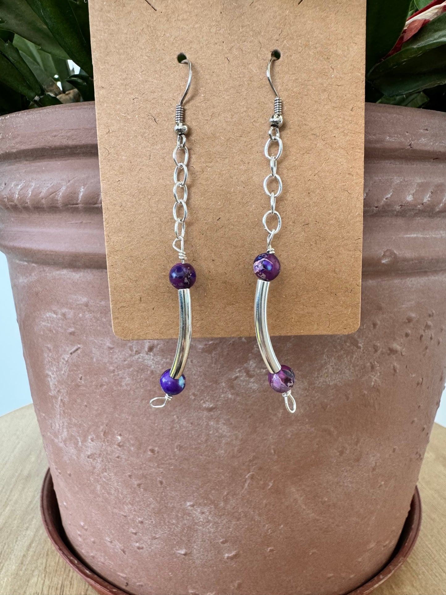 Silver earrings with curved and purple beads