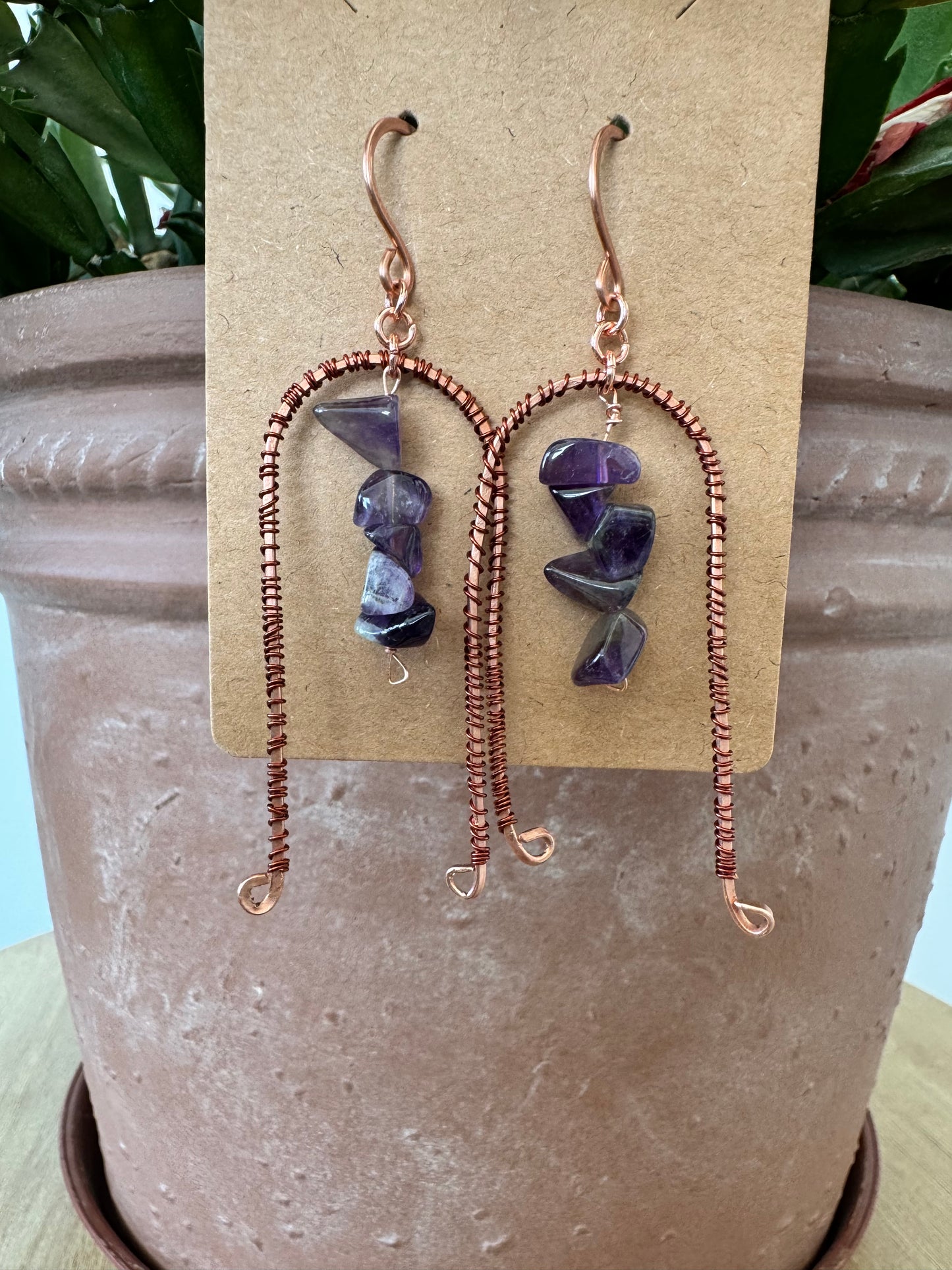 Arched copper earrings with purple stones